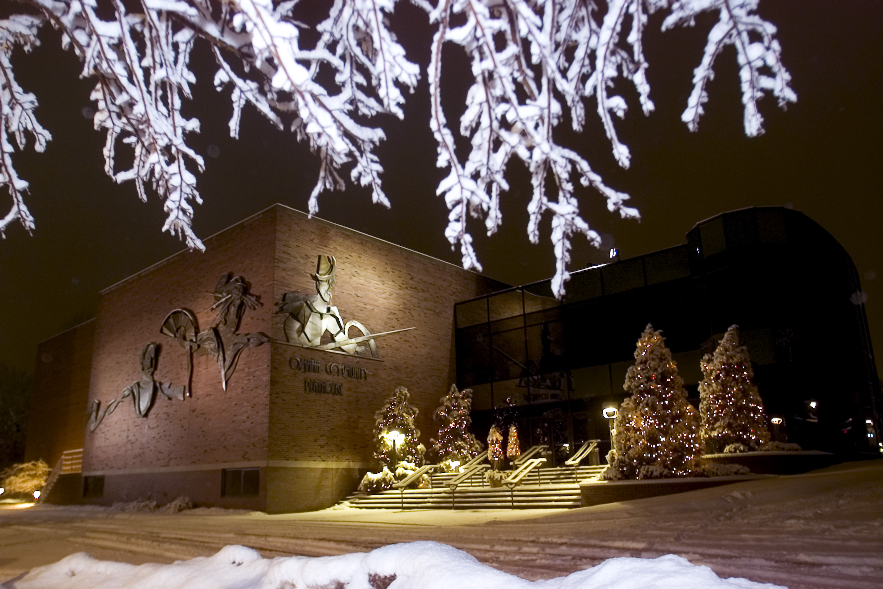 Outside of the Omaha Community Playhouse with holiday decorations on the trees.