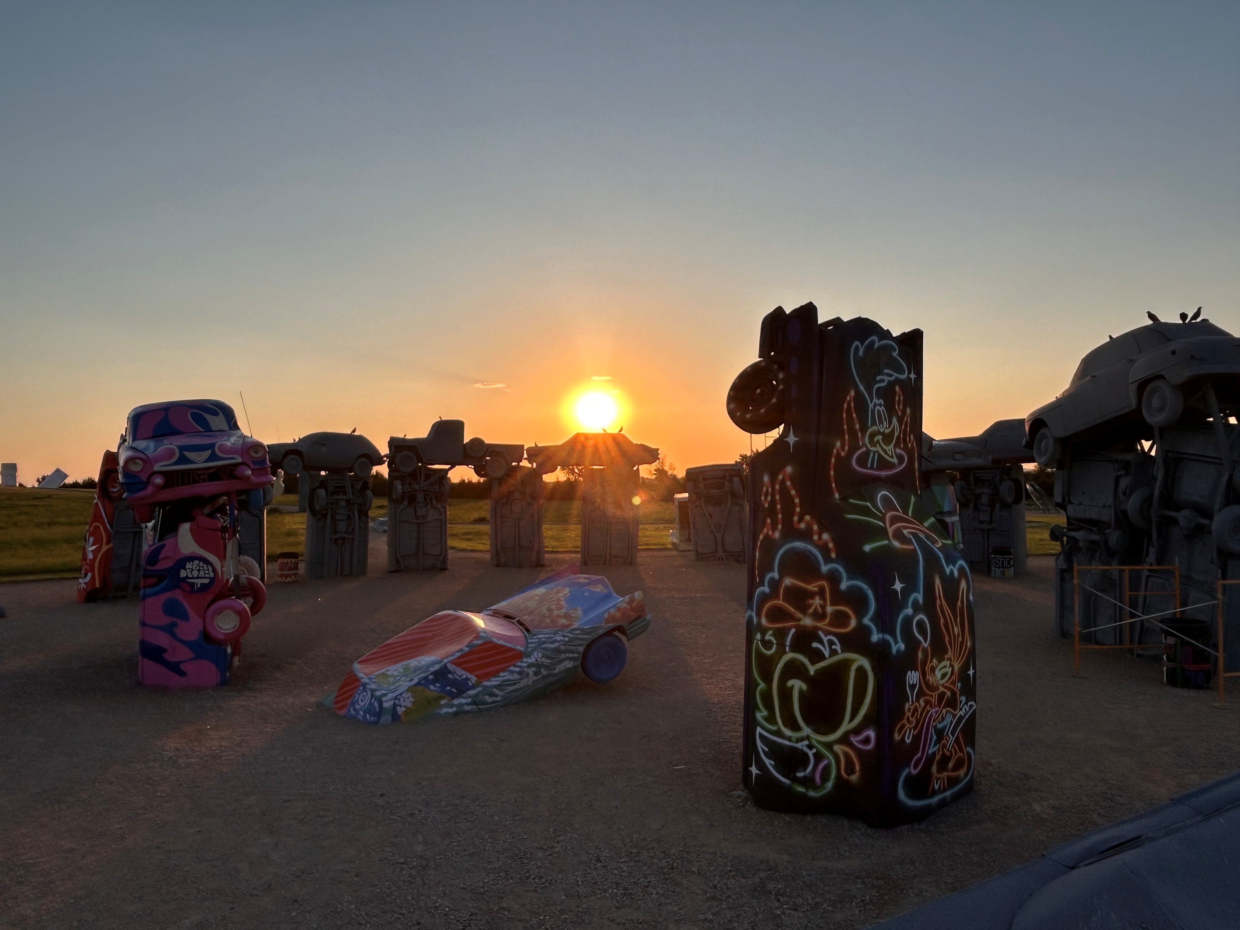 Roadside attraction Carhenge, a replica of Stonhenge made from spray painted cars, at sunset.