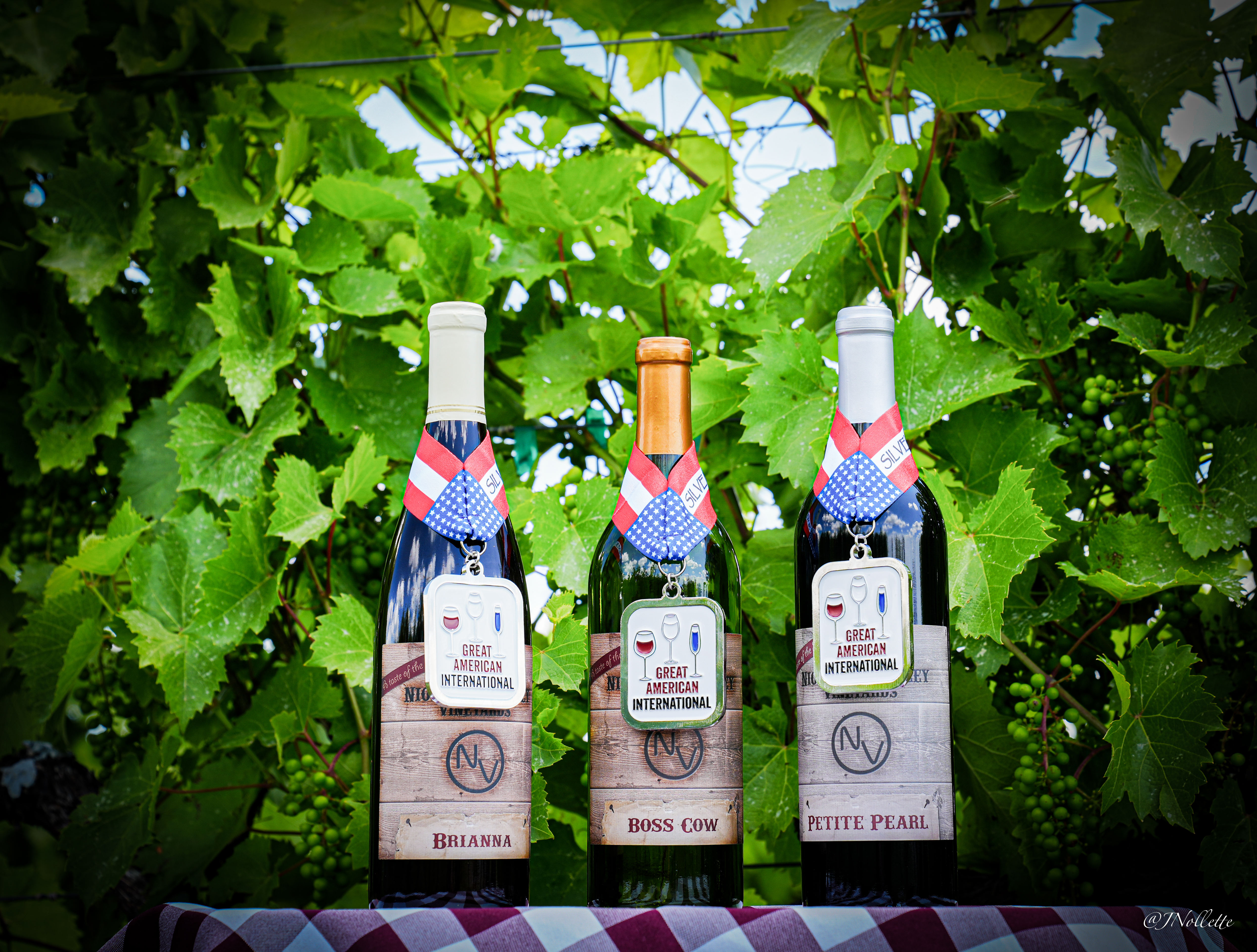 Three wine bottles on display.