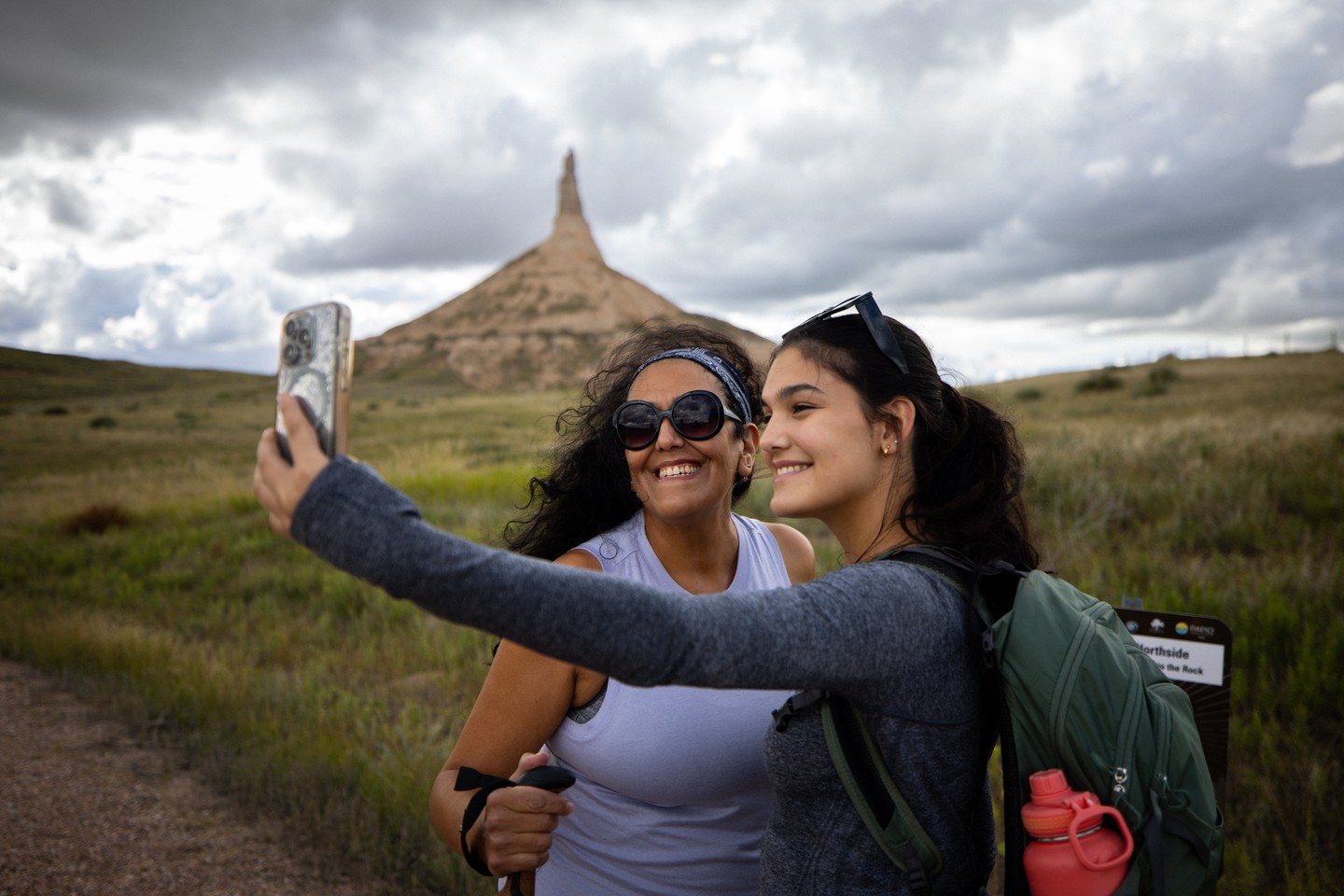 Two women pose for a selfie while hiking the trails at Chimney Rock National Historic Site.