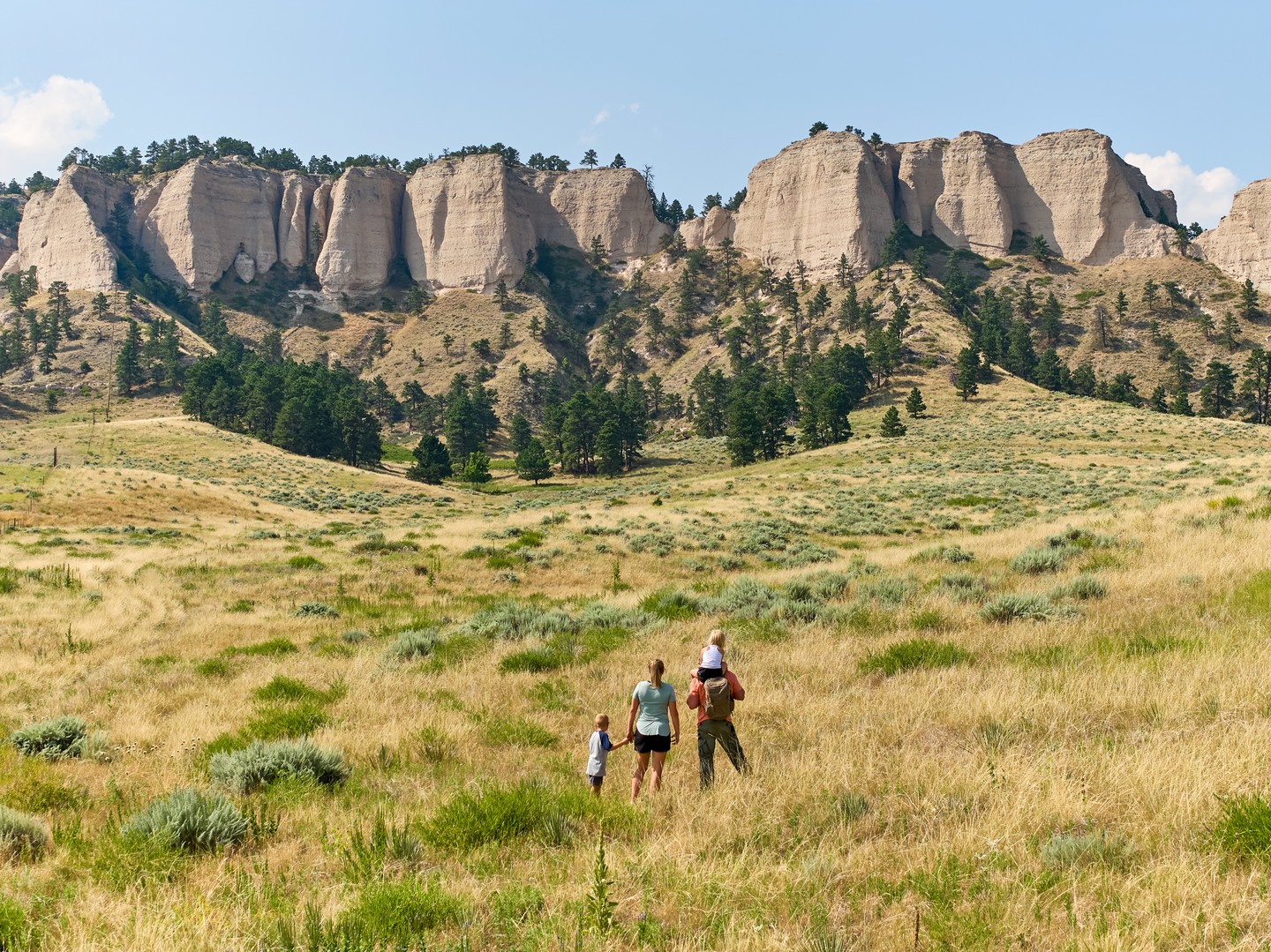 A family of four taking in the stunning bluffs and cliffs at Fort Robinson State Park.