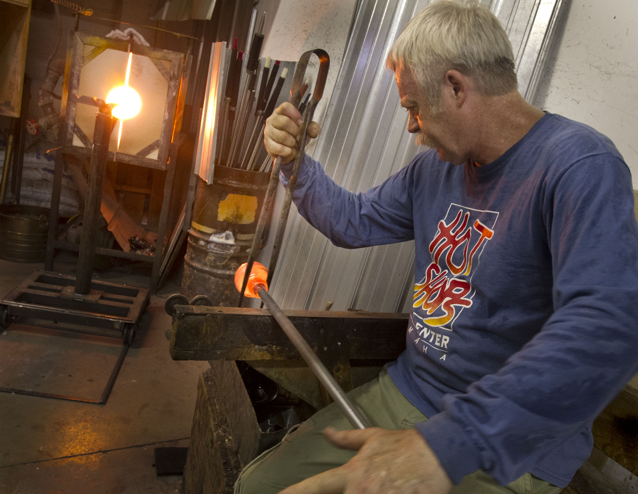 Glass artist working on a piece in the Hot Shops