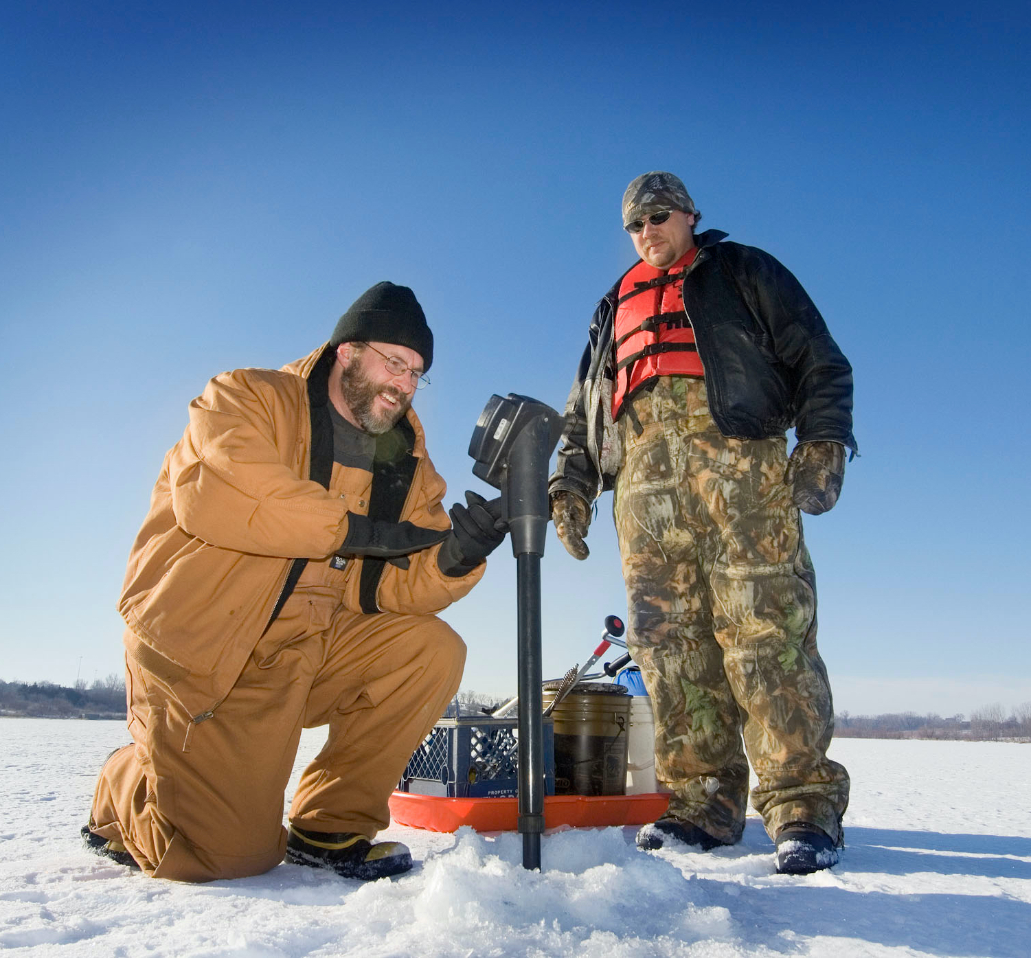 Two anglers ice fishing at Chalco Hills in Papillion.