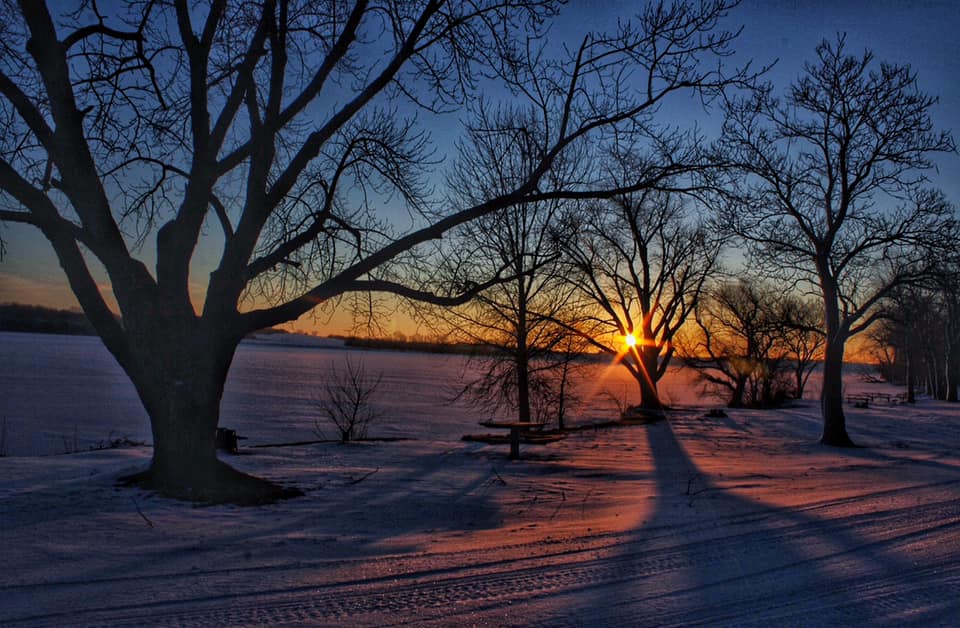 Sunrise over a snowy lake