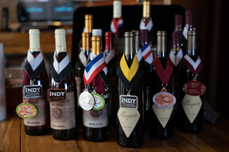 Wine bottles with awards and medals around them from Niobrara Valley Vineyards.