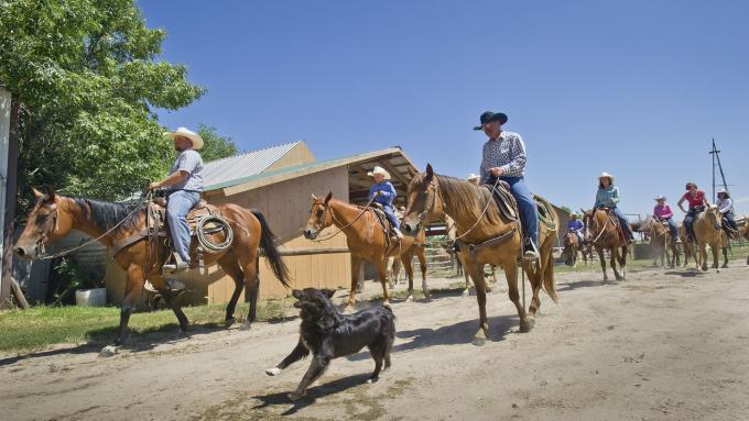 A group of horseback riders travel along a dirt path at Rowse's 1+1 Ranch in Burwell, NE.
